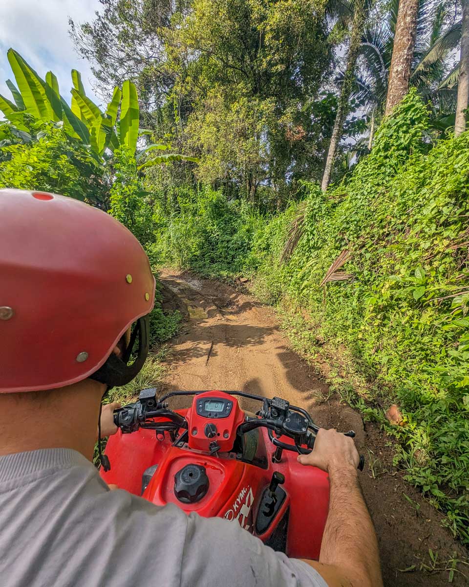 Daniel-driving-an-ATV-down-a-dirt-road-in-Koh Samui Thailand