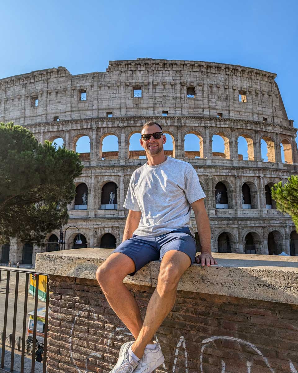 Daniel poses for a photo with the Colosseum