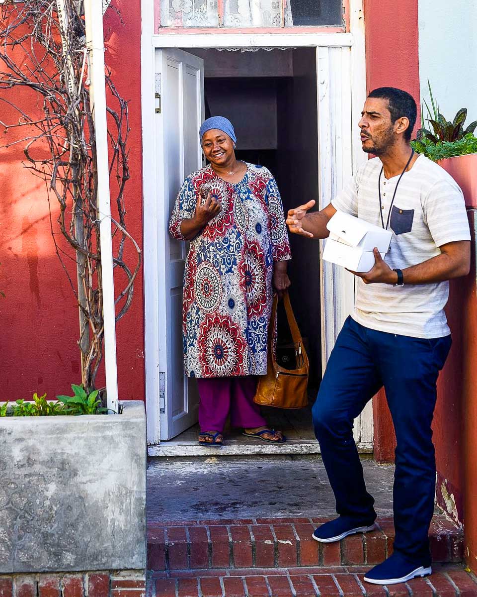 One Day Africa a guide talks with a woman on a bike tour of Soweto from Johannesburg South Africa