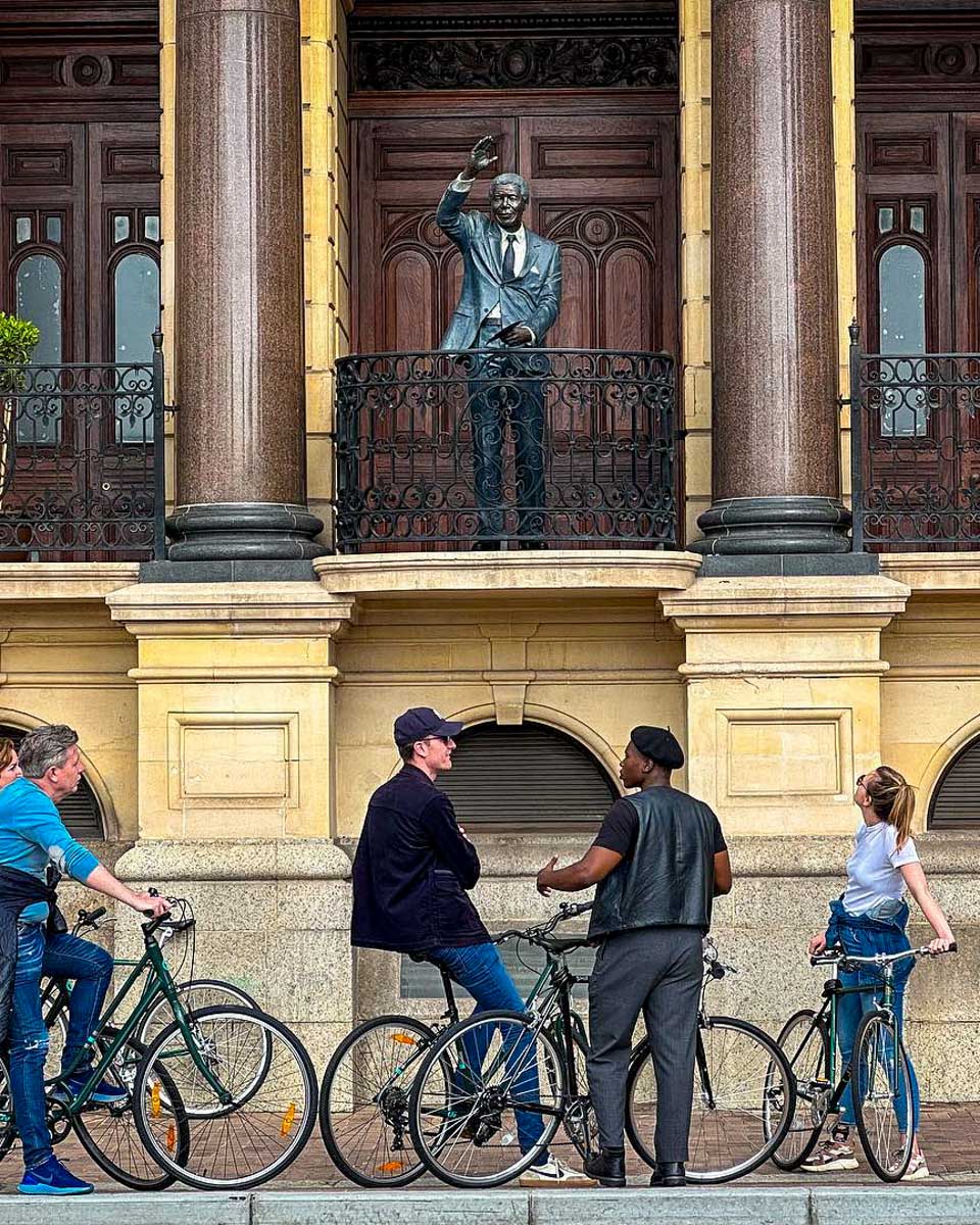One Day Africa a guide talks with people on a bike tour of Soweto from Johannesburg South Africa