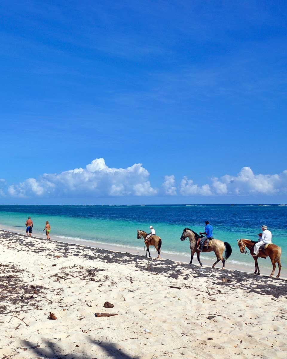 People-ride-horseback-on-a-beach-in-Roatan Honduras