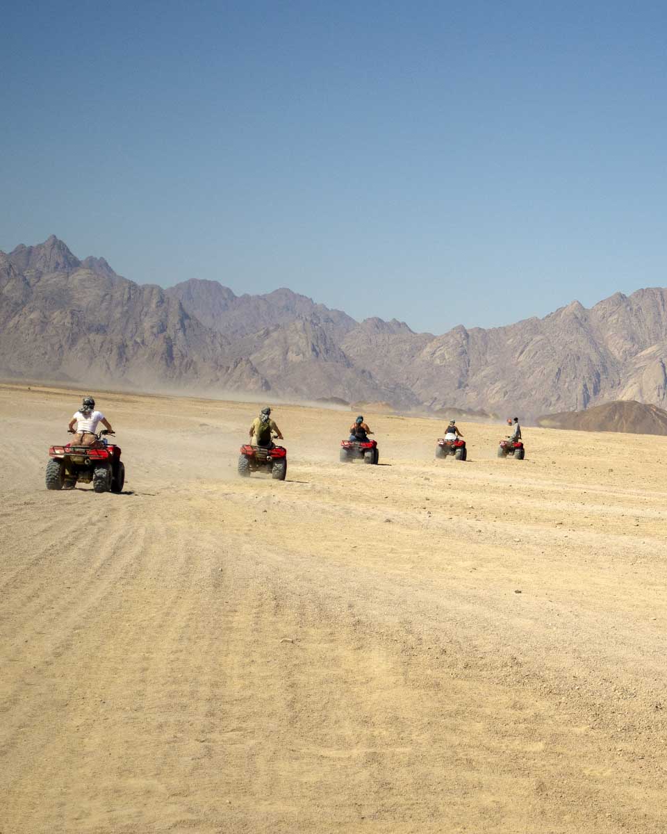 People-ride-through-the-desert-on-atvs-on-a-tour-from-Hurghada-Egypt