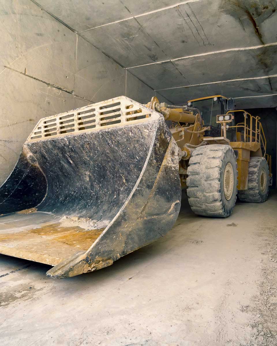 A bulldozer in the carrara marble quarries on a tour from Pisa Italy