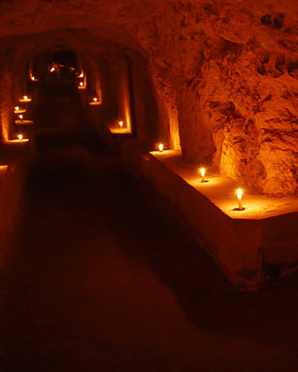 A candle lit underground tunnel seen on a tour in Cagliari Italy