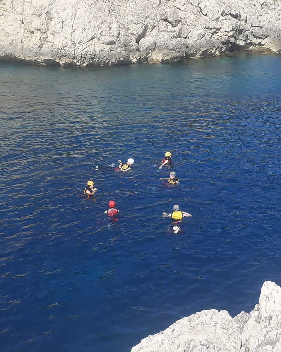 A group of people swimming after cliff jumping on a tour from Palma de Mallorca Spain