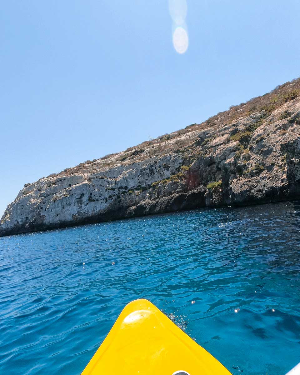 A-person-kayaks-around-Cala-Suaraccia-on-a-tour-in-Mykonos-Greece