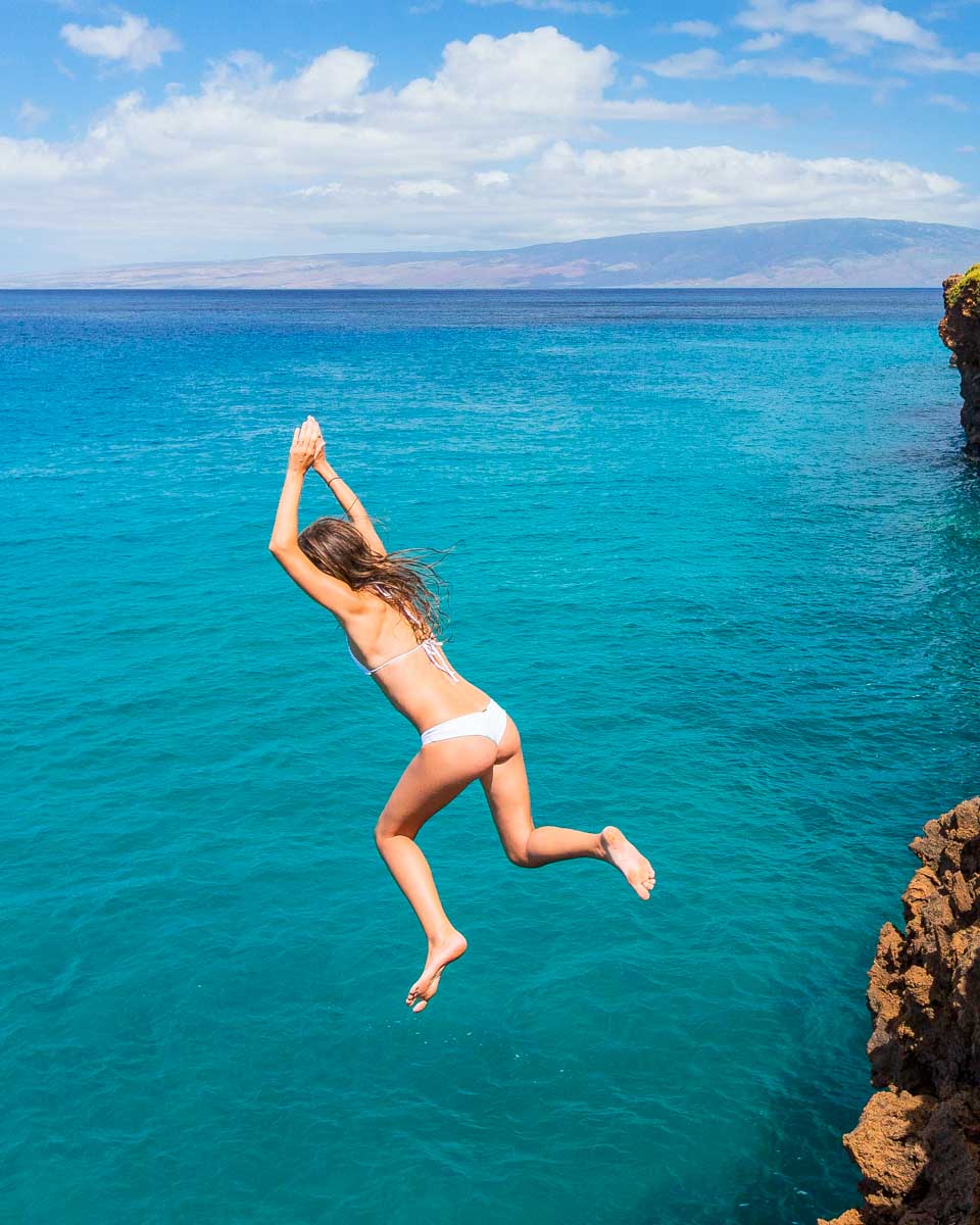 A woman cliff jumping in Mallorca Spain