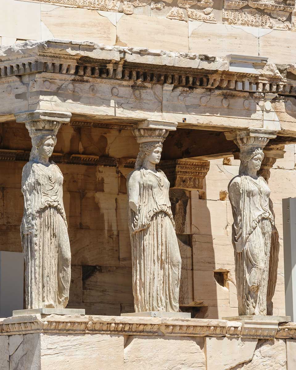 Ancient statues seen on a tour if the Acropolis in Athens Greece