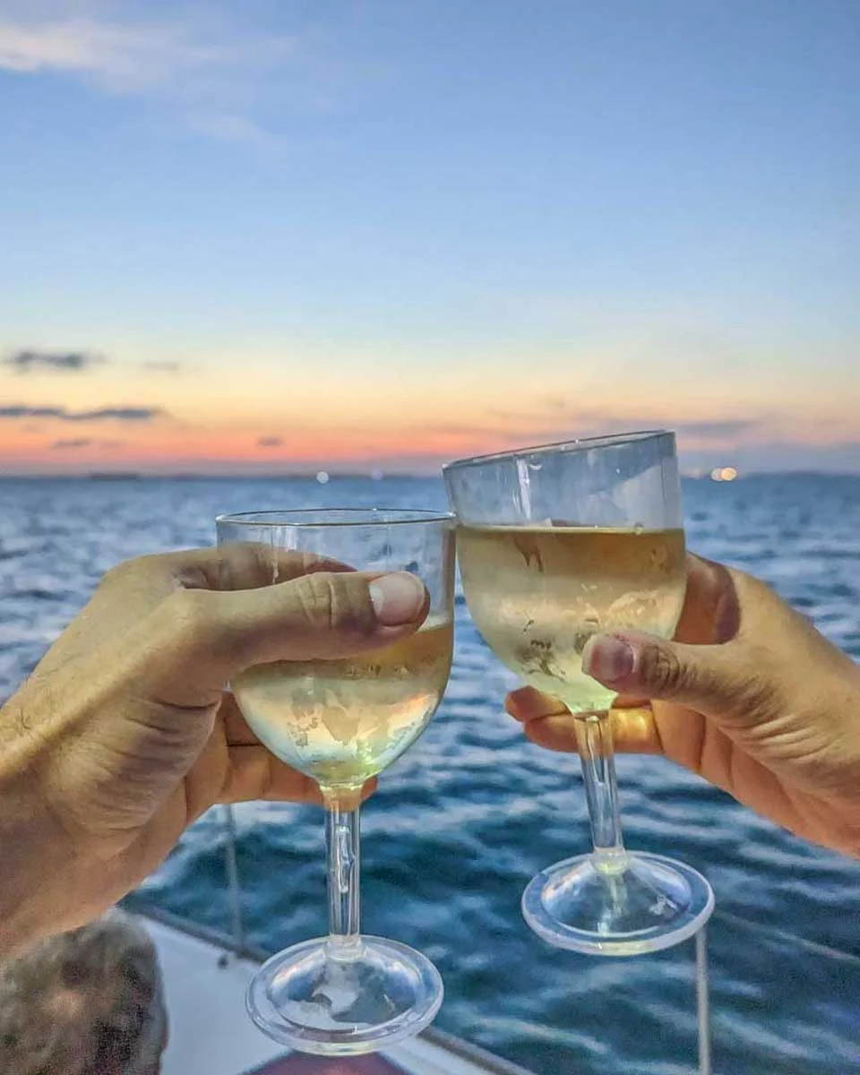 Bailey-and-Daniel-cheers-with-wine-at-sunset-cruise-in-Turks and Caicos