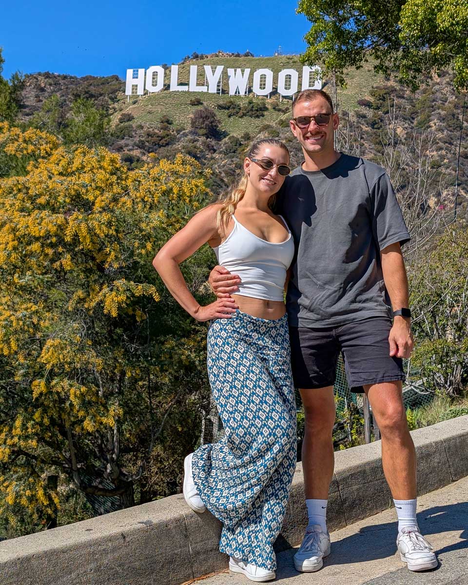 Bailey and Daniel stand by the Hollywood sign in Los Angeles, California, United States