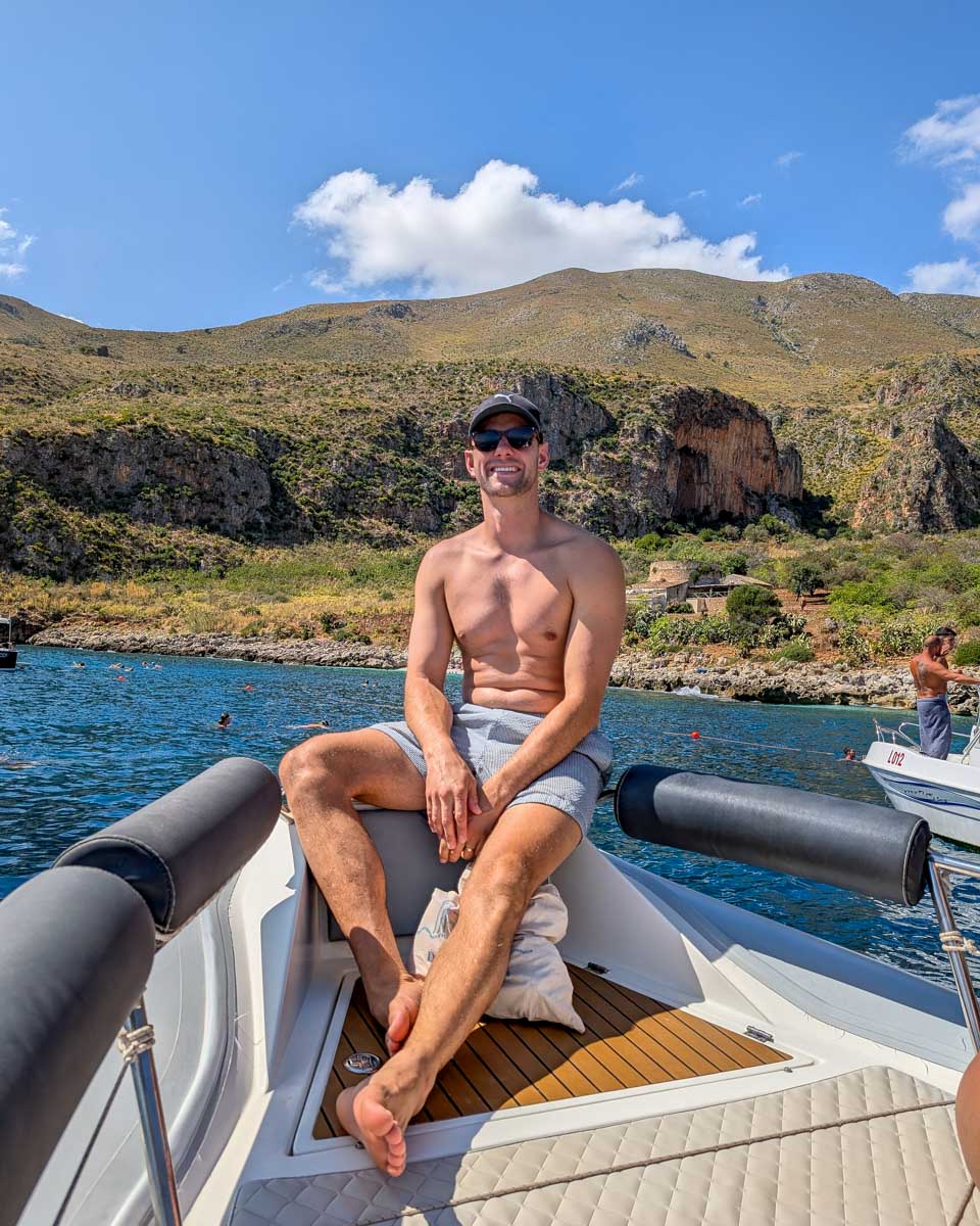 Daniel-sits-on-a-boat-on-a-boat-tour-from Sicily Italy