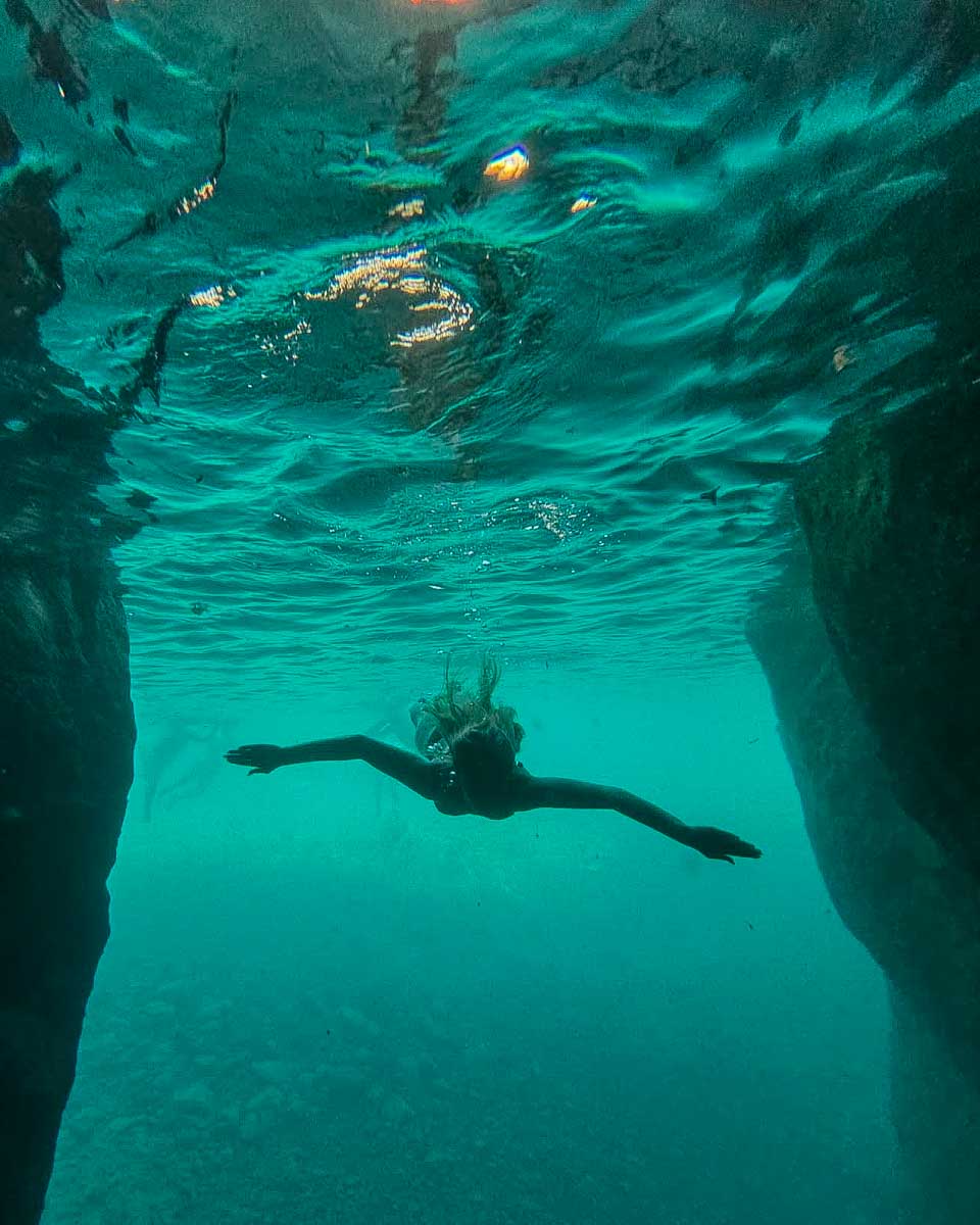 Govalenciadaytours a person swims in a thermal pool on a tour from Valencia Spain