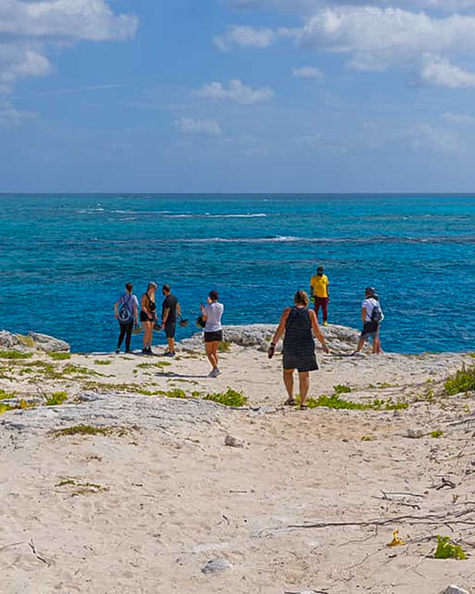 J&S Caribbean Rentals people walk by the ocean on a tour from Turks and Caicos