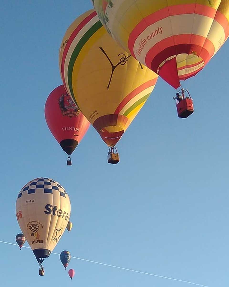 Multiple hot air balloons in the sky seen on a hot air balloon tour in Palma de Mallorca Spain
