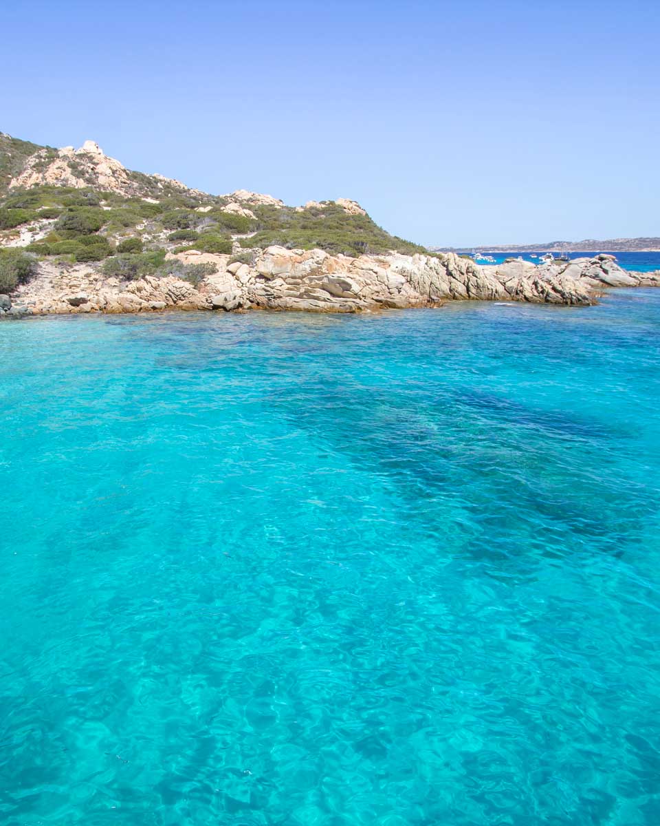 The clear turquoise water at Cala Santa Maria on a boat tour in Sardinia