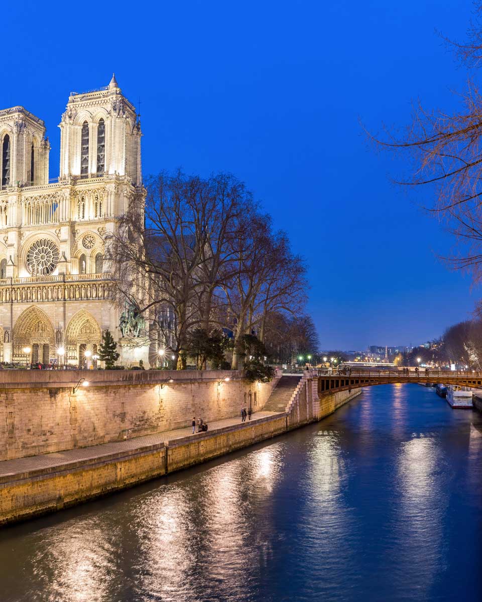 Views of the Seine River and Notre Dame at night on a cruise in Paris France