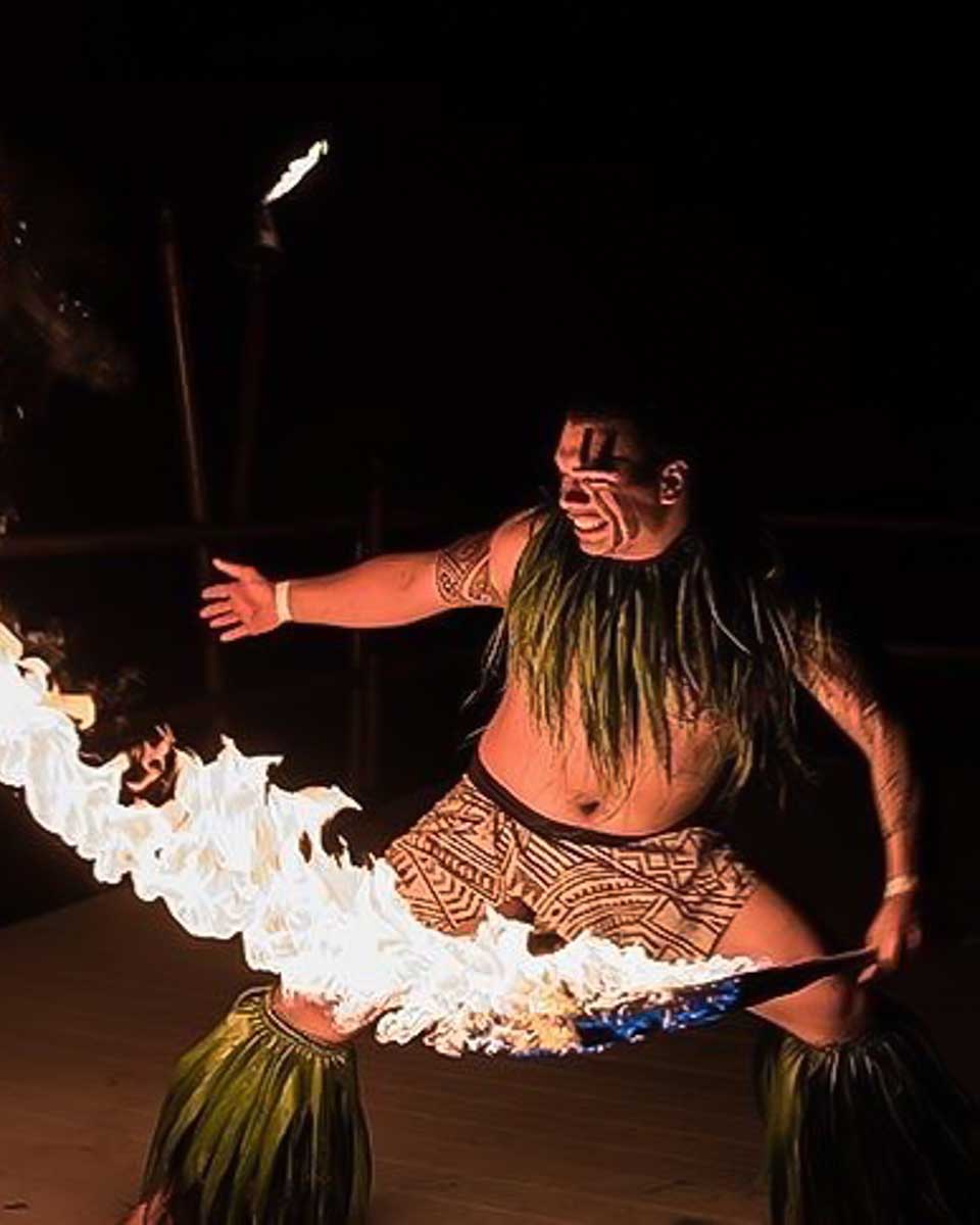 Voyagers of the Pacific Luau a man does a fire show at a luau on Big Island Hawaii