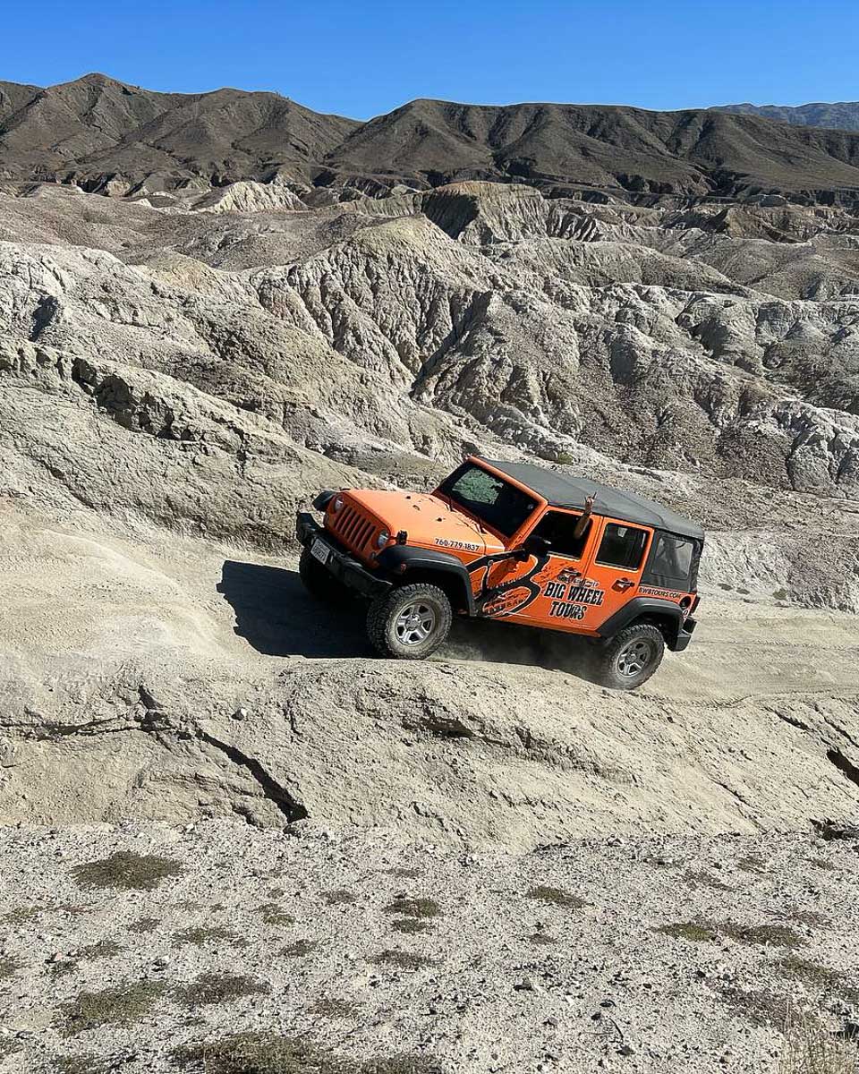 A 4x4 truck drives in the Mojave Desert on a tour from Palm Springs California