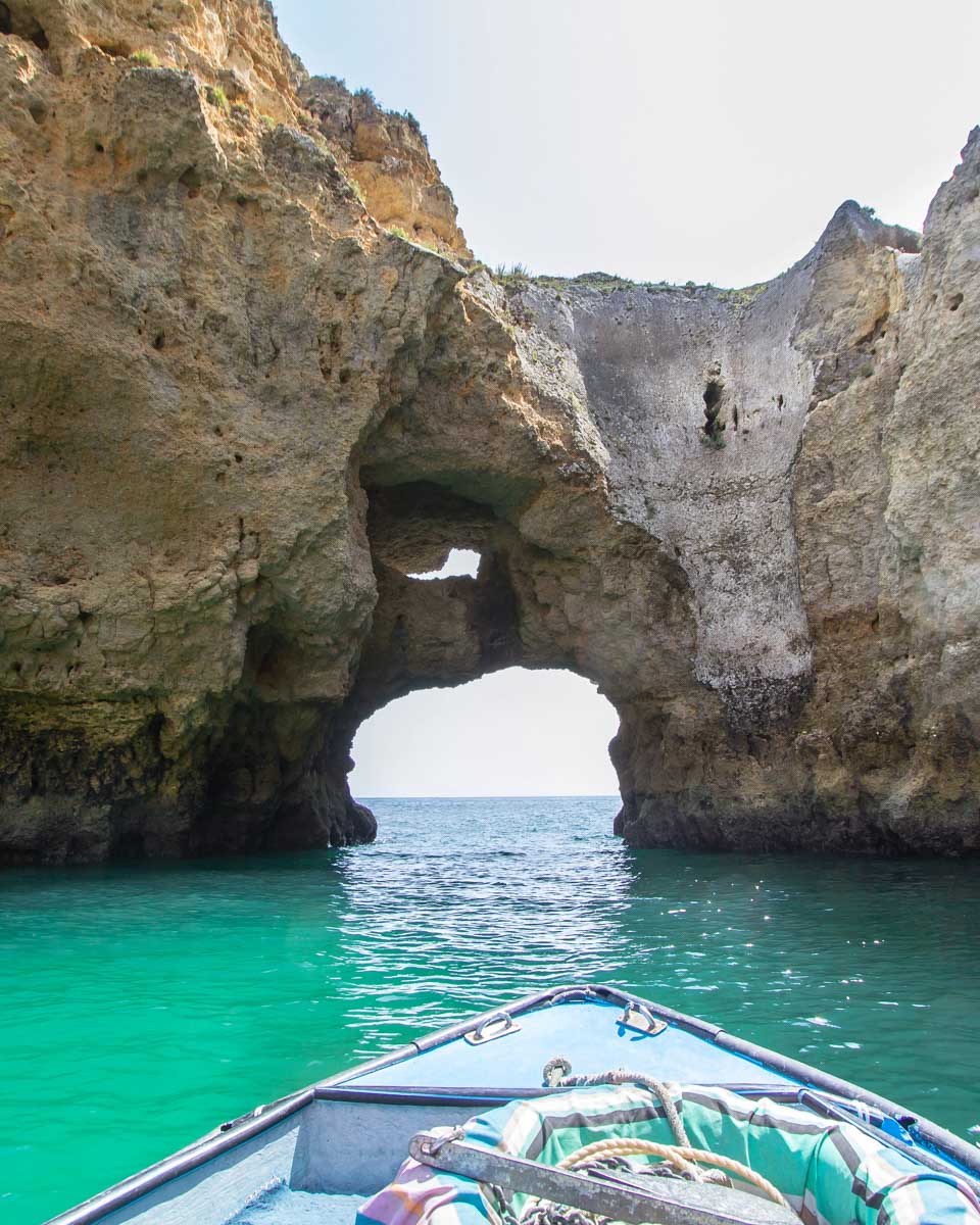 A boat heading through the Ponta da Piedade on a boat tour in Lagos Portugal