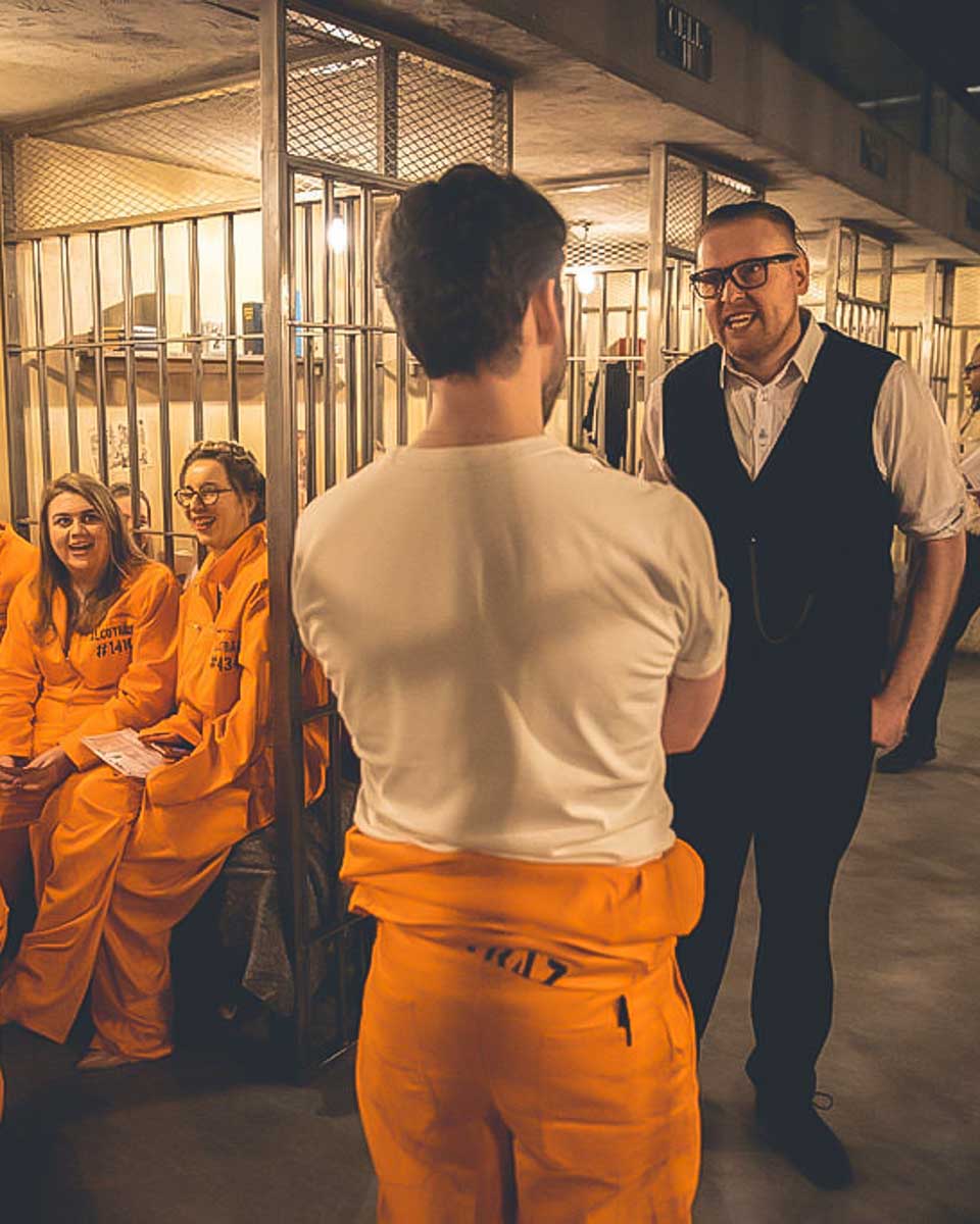A man chatting with the warden at the Alcotraz Prison experience