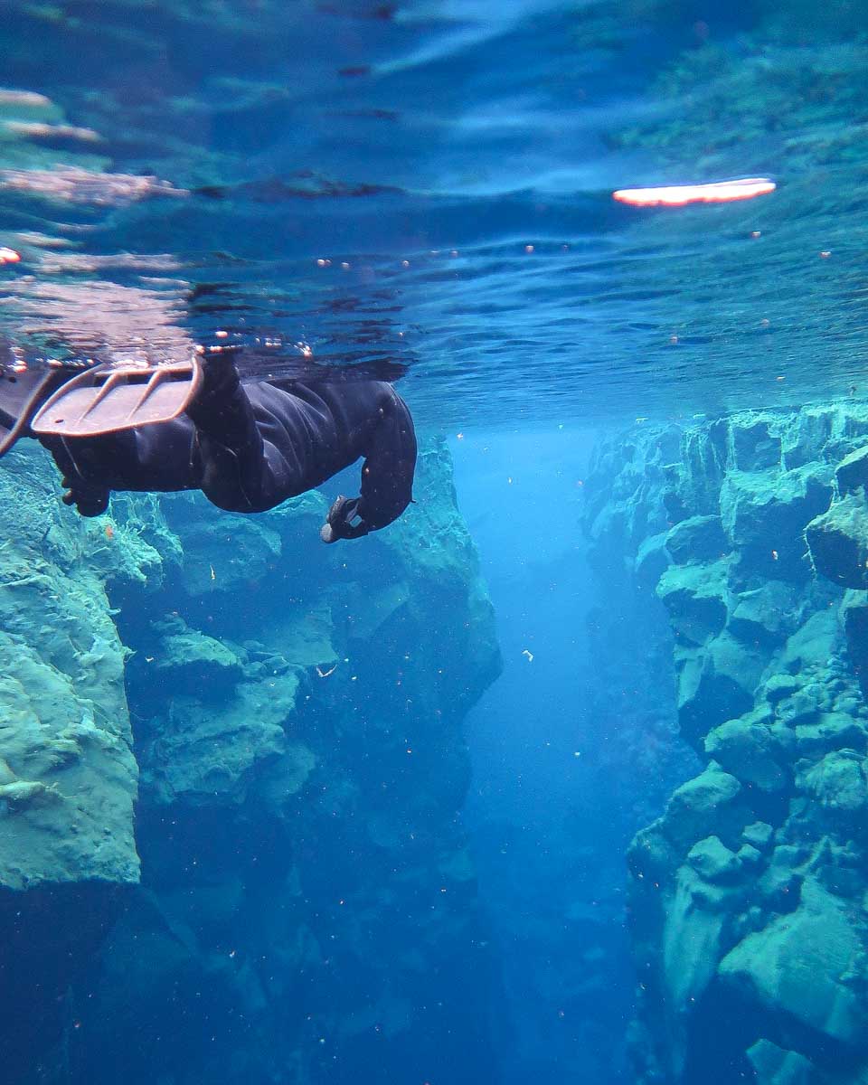 Dive.is - PADI 5 Star Dive Center Iceland a person snorkels between tectonic plates in Reykjavik Iceland