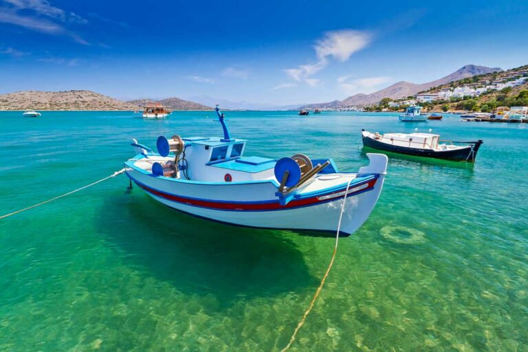 Fishing boats at the coast of Crete Greece on a sunny day