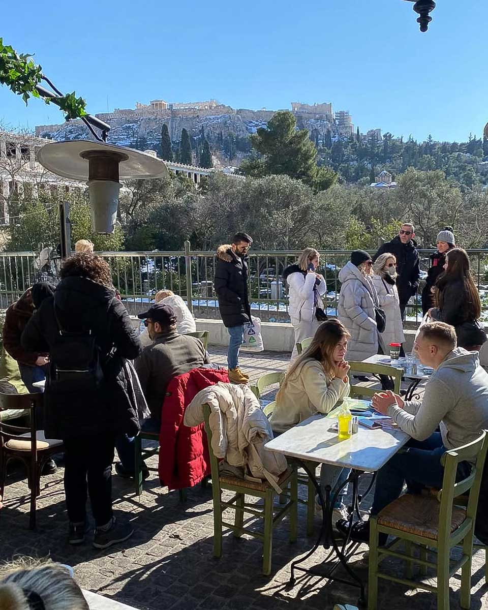 People eat a meal outside at Diodos Ancient Agora Restaurant in Athens Greece
