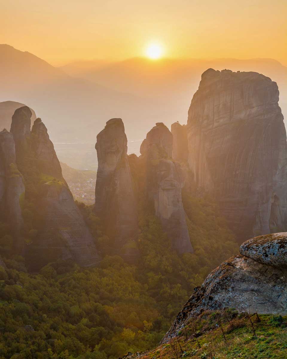 The sun setting behind the rocks in Meteora on a tour from Athens Greece