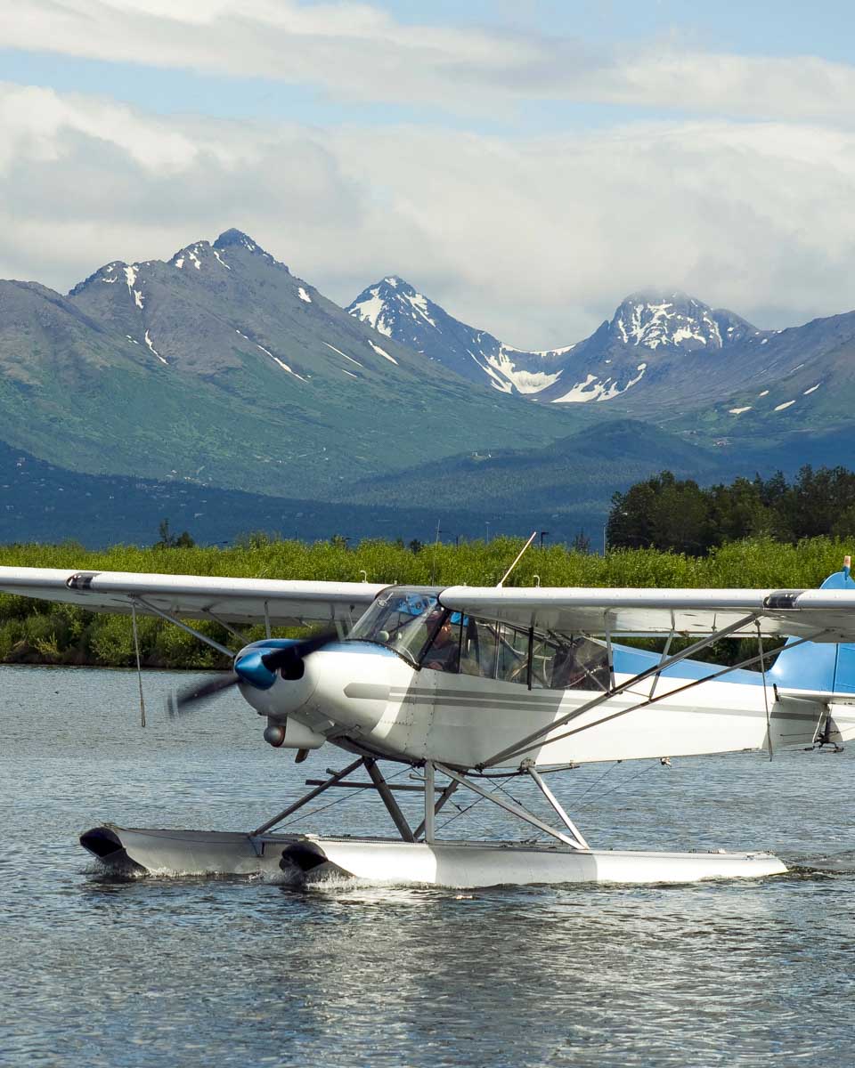 A sea plane lands on Lake Hood seen on a tour of Anchorage Alaska
