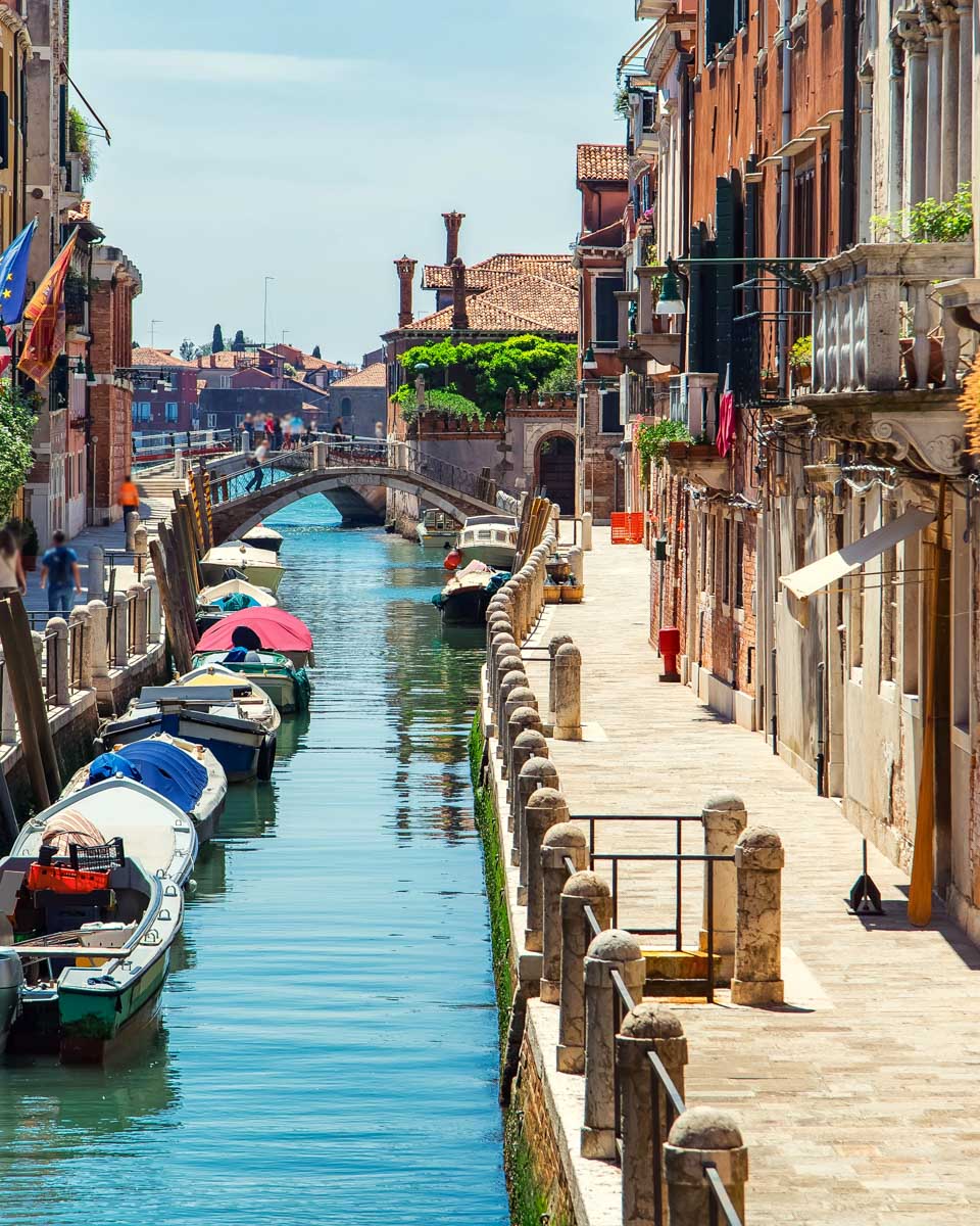 A street and canal in Venice Italy