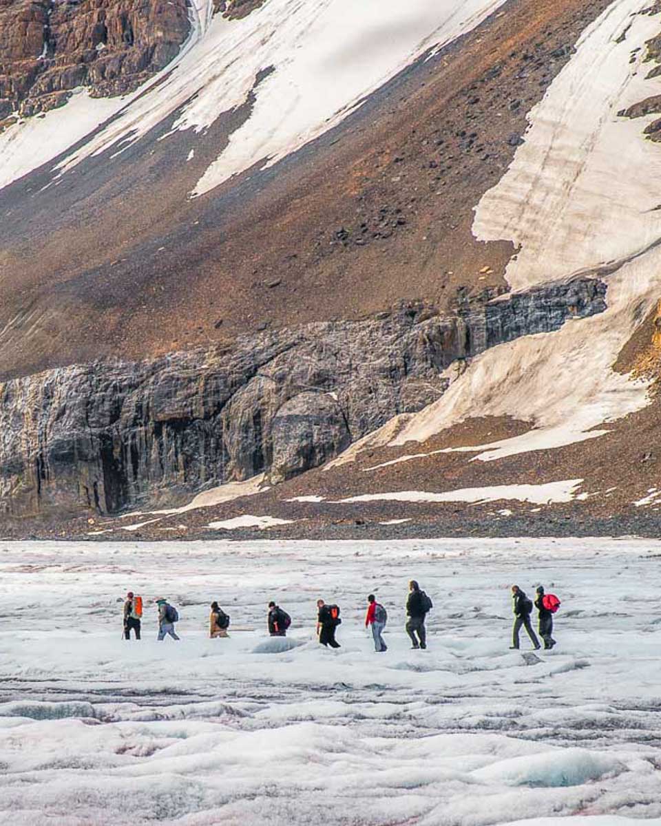 A-tour-group-walk-on-the-Athabasca-Glacier-in-the-Columbia-Icefield-on-a-trekking-tour