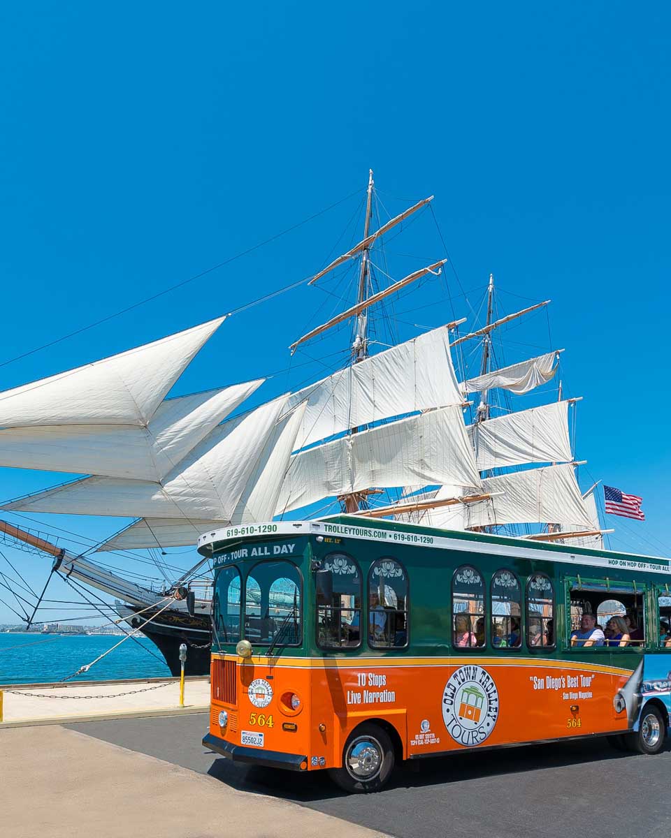 A trolley bus driving along the waterfront in San Diego California
