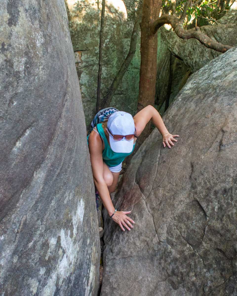 Bailey climbs over a rock during a sunset hike in Lake Tahoe