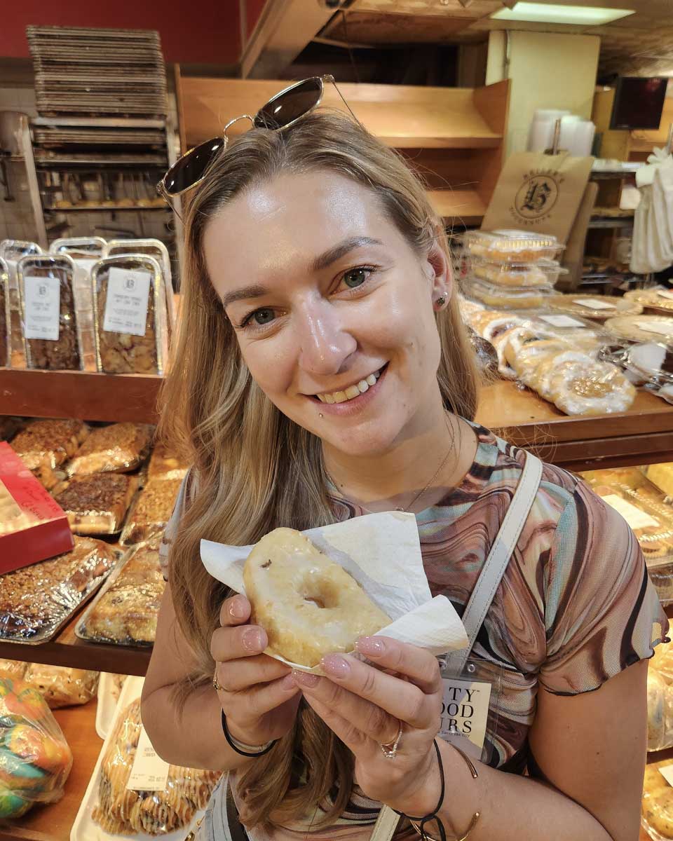 Bailey-eating-a-donut-on a tour in Portland Maine