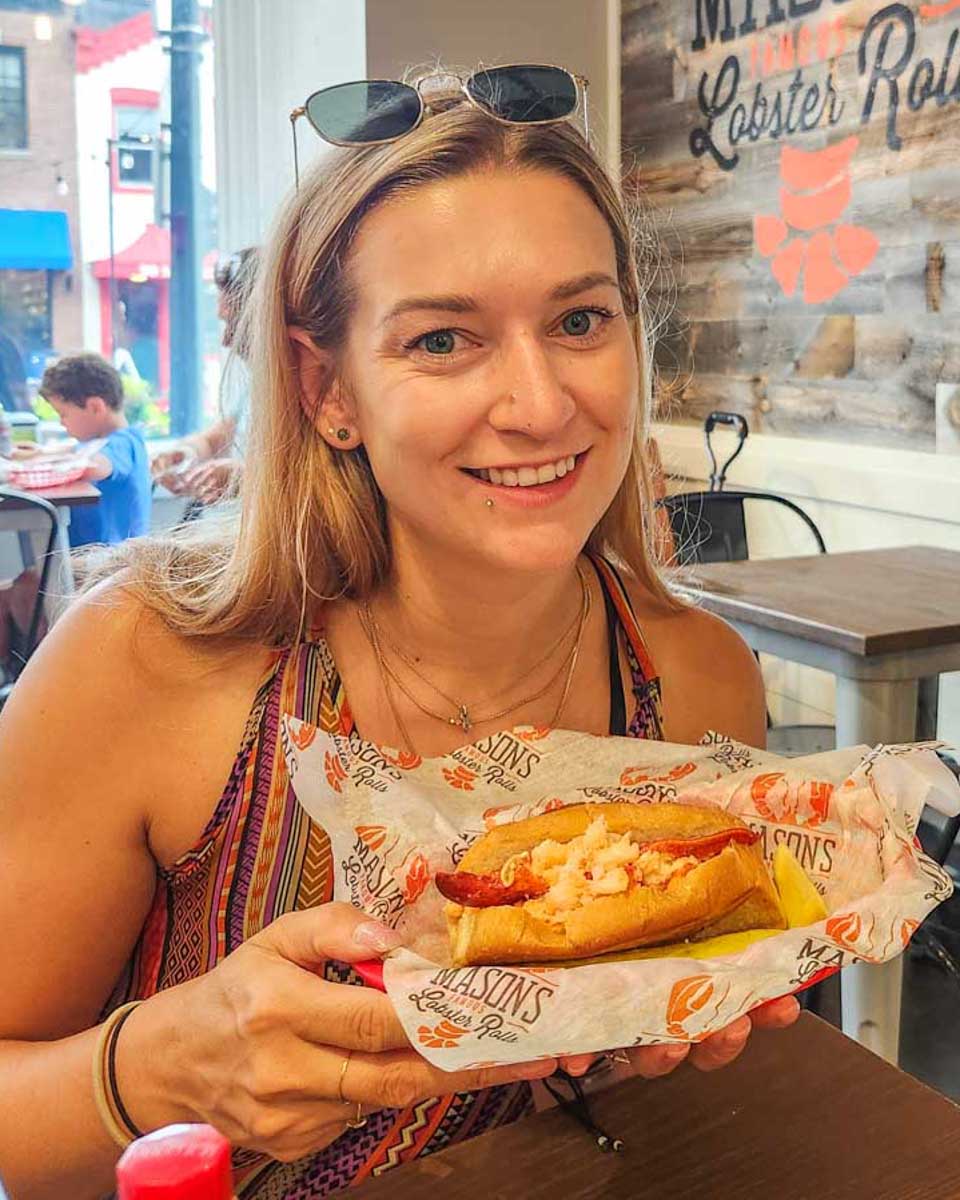 Bailey-with-a-lobster-roll-in-Boston Massachusetts