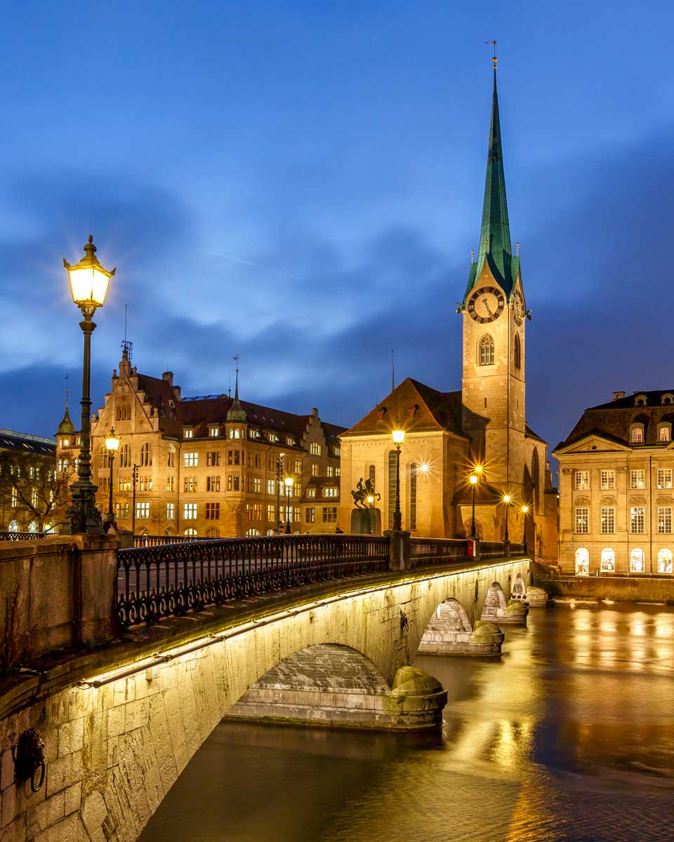 Illuminated Fraumunster Church and River Limmat in Zurich Switzerland