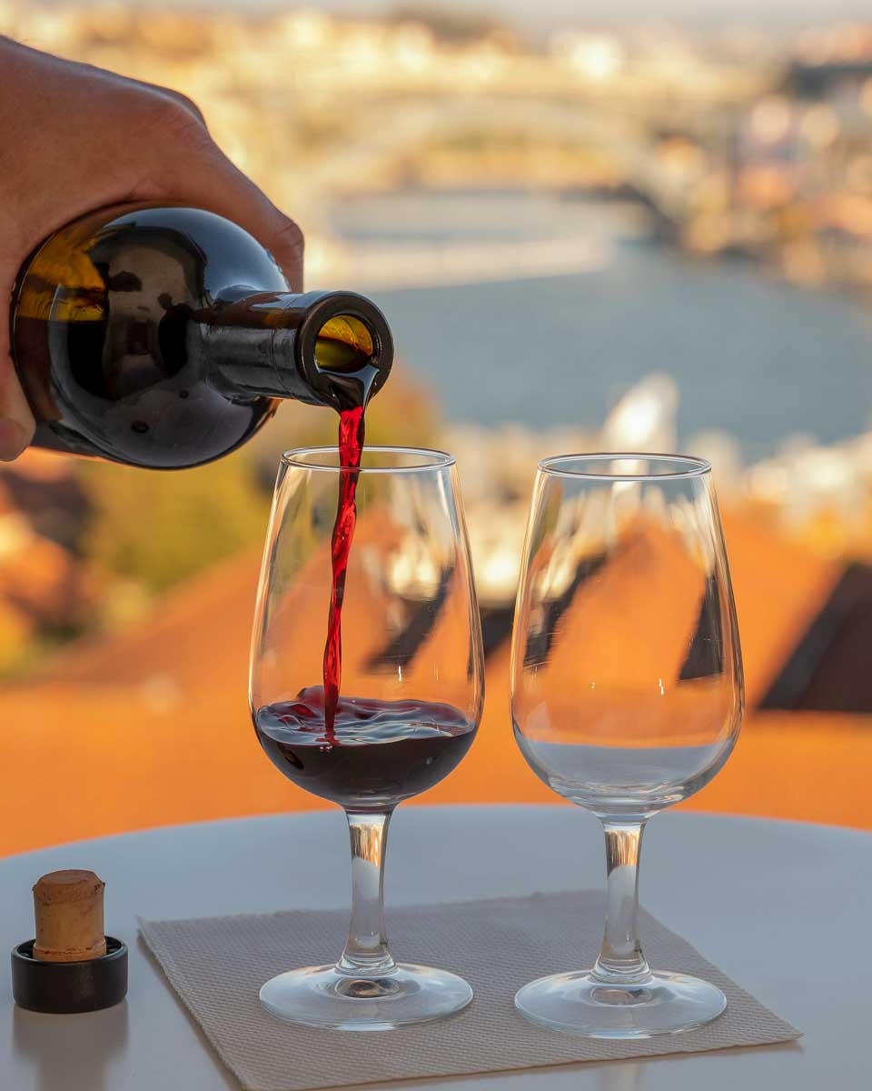 Port wine being poured at sunset in Vila Nova de Gaia Porto Portugal