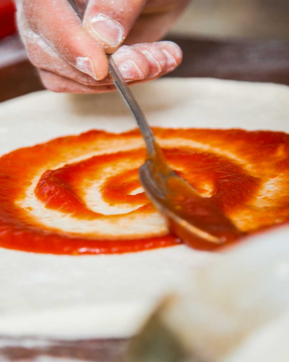 A-person-making-pizza-in-Naples-Italy
