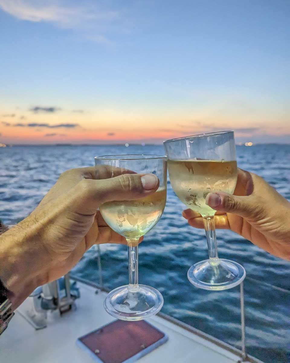 Bailey-and-Daniel-cheers-with-wine-at-sunset-on-a-cruise-in-Darwin Australia