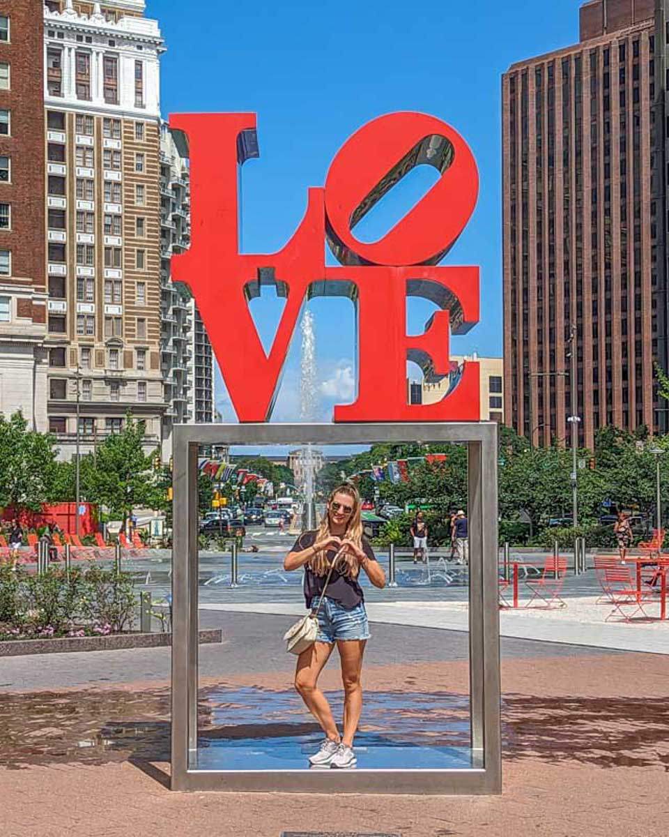 Bailey-poses-for-a-photo-with-the-Love-Park-sign-at-Love-Park-in-Philadelphia