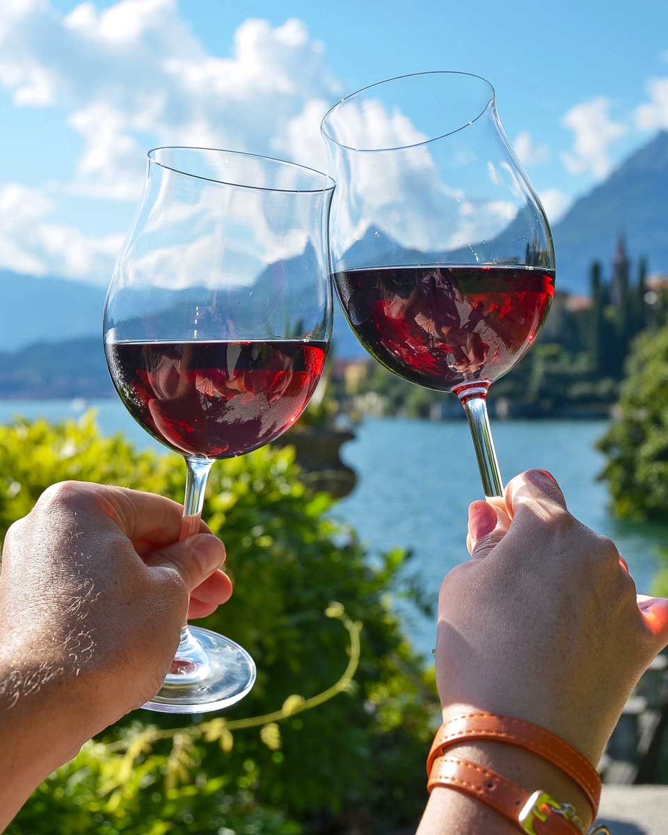 Daniel-and-Bailey-hold-wine-glasses-in Menaggio on Lake Como Italy