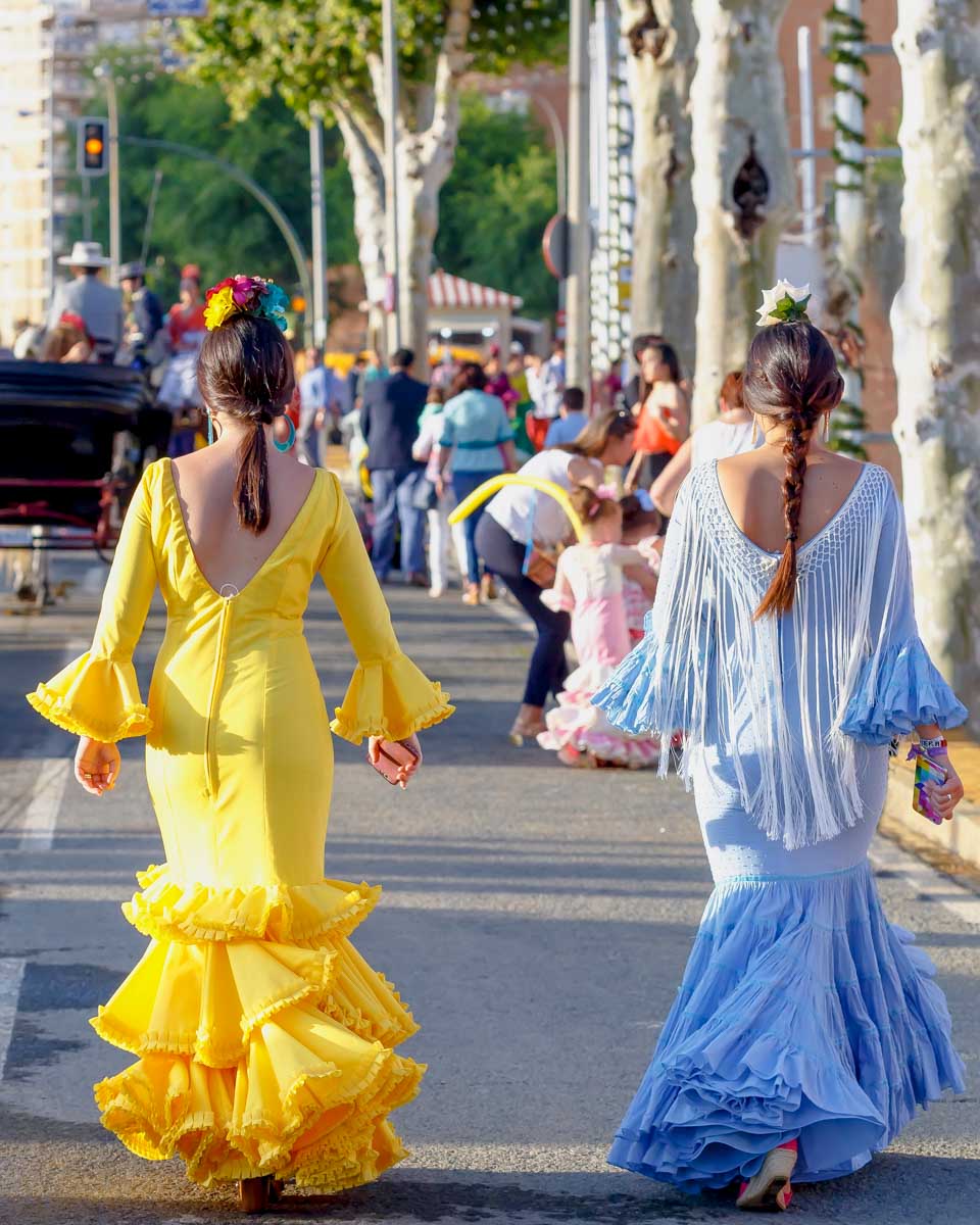 Women wear flamenco dresses during Feria de Abril in Seville Spain