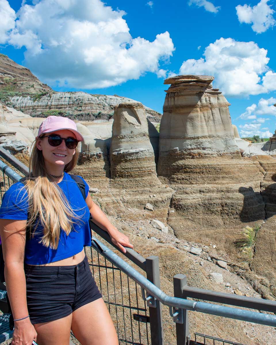 Bailey-poses-with-the-Drumheller-hoodoos-on a tour from Calgary Alberta
