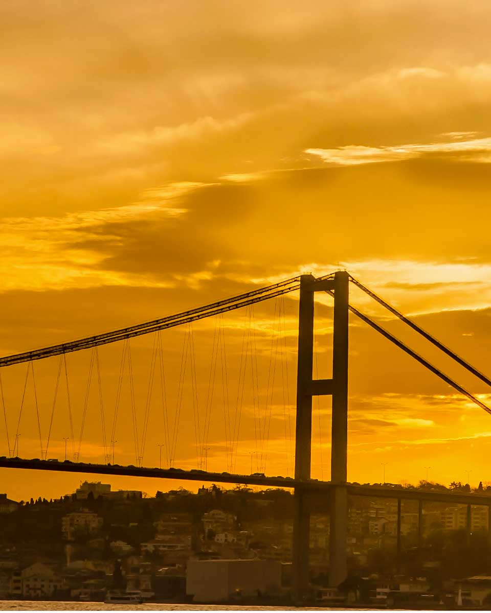 Bosphorus Bridge seen at sunset on a cruise in Istanbul Turkey