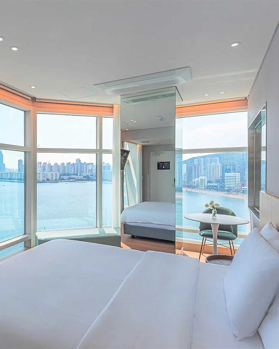 Hotel room with a city and ocean view at The Marine View Hotel in Busan