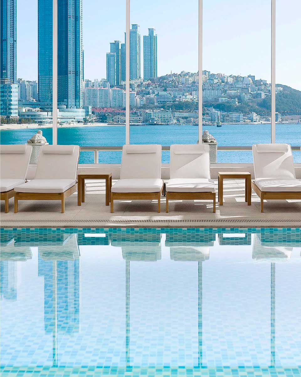 The indoor pool area with a view of the coast at The Westin Josun Busan