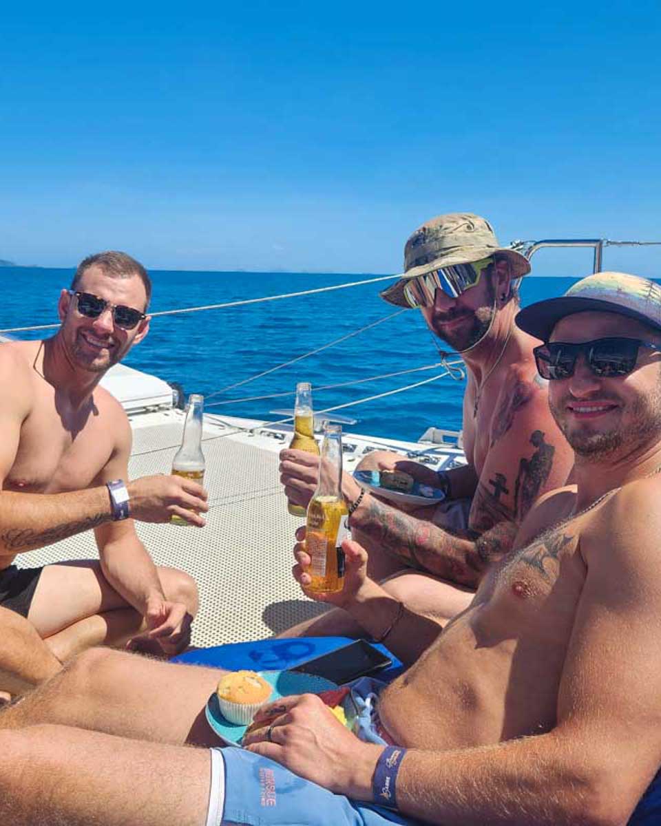 Daniel-and-friends-enjoy-a-beer-on-the-deck-of-a catamaran in Puerto Rico
