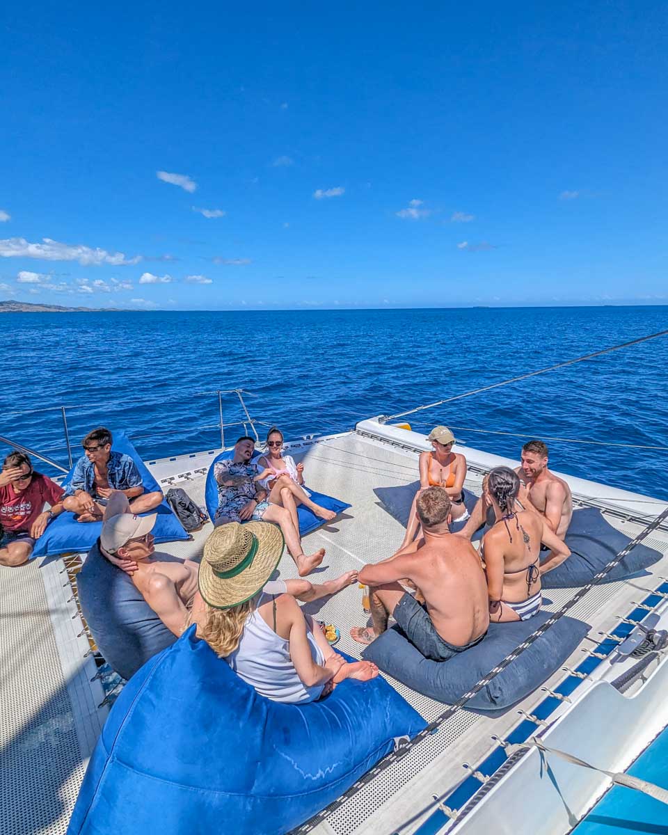 A-group-of-people-relax-on-the-seating-on-a-catamaran-in-Bonaire