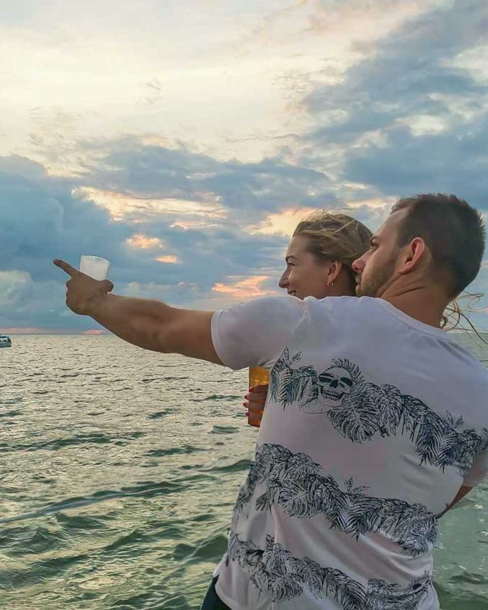 Daniel-points-to-something-while-on-a-sunset-cruise-in-Rio de Janeiro Brazil