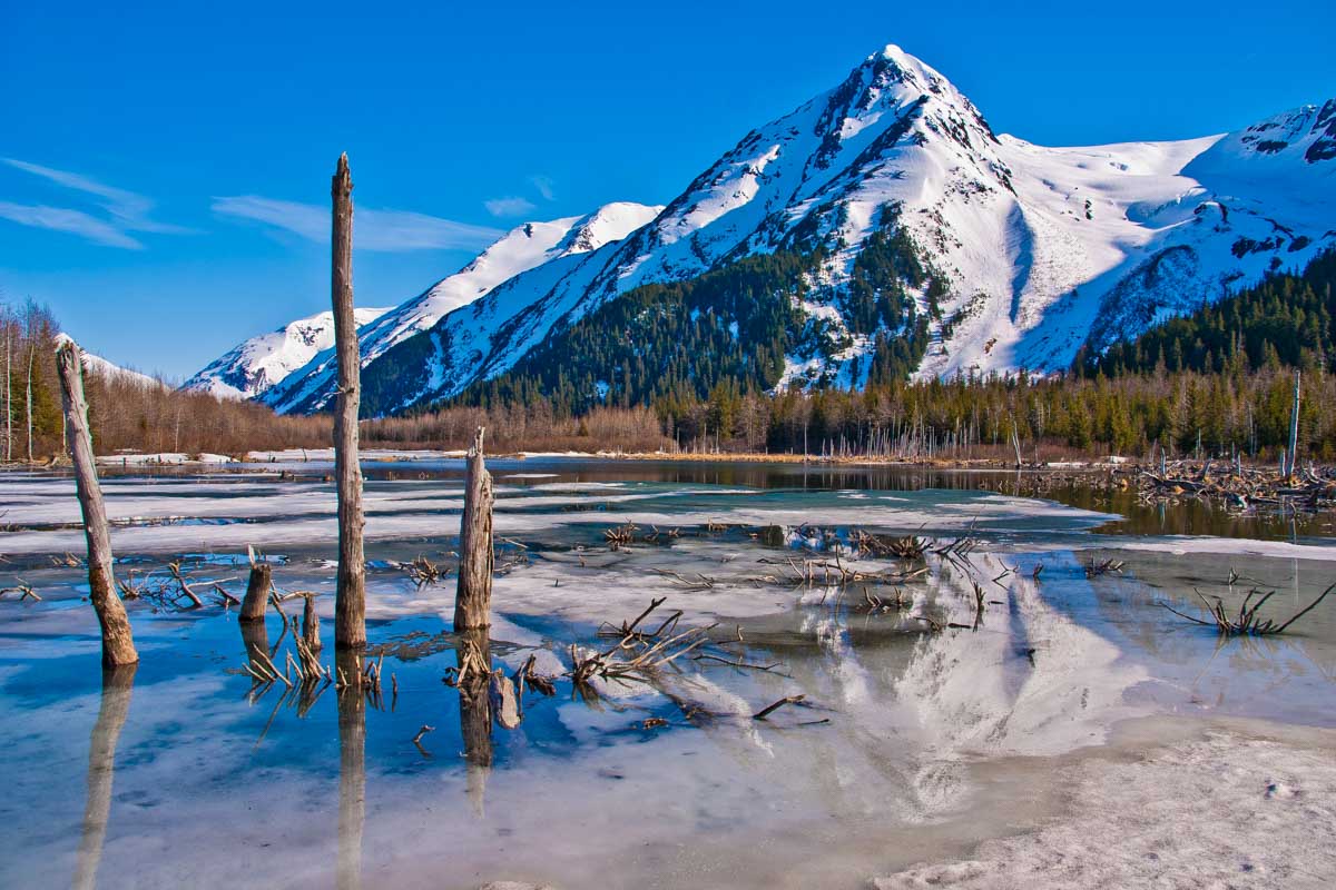 The view of a partially frozen lake and mountain seen in Anchorage Alaska